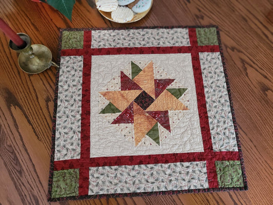 Quilt with star pattern on a wooden surface