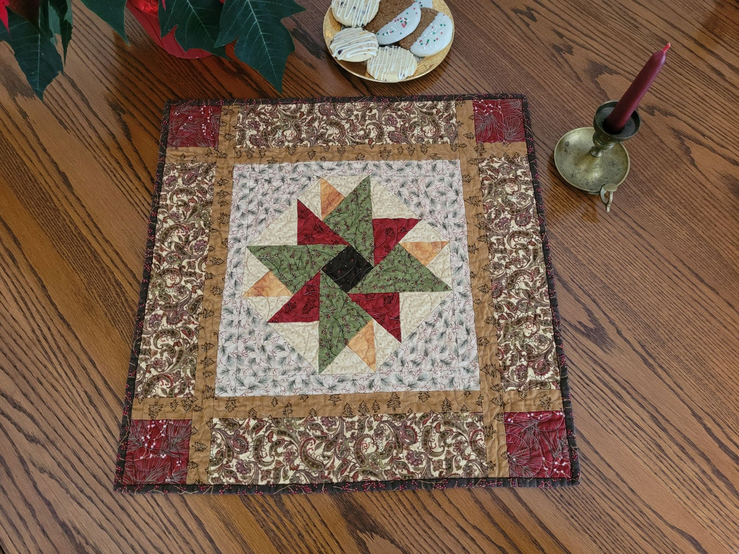 Christmas Star quilt on wooden table with holiday decor 