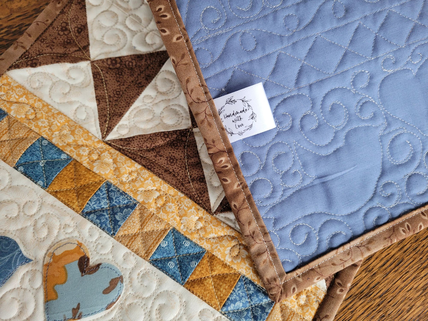 Showing back of quilted table runner with the 'Handmade with Love' label.