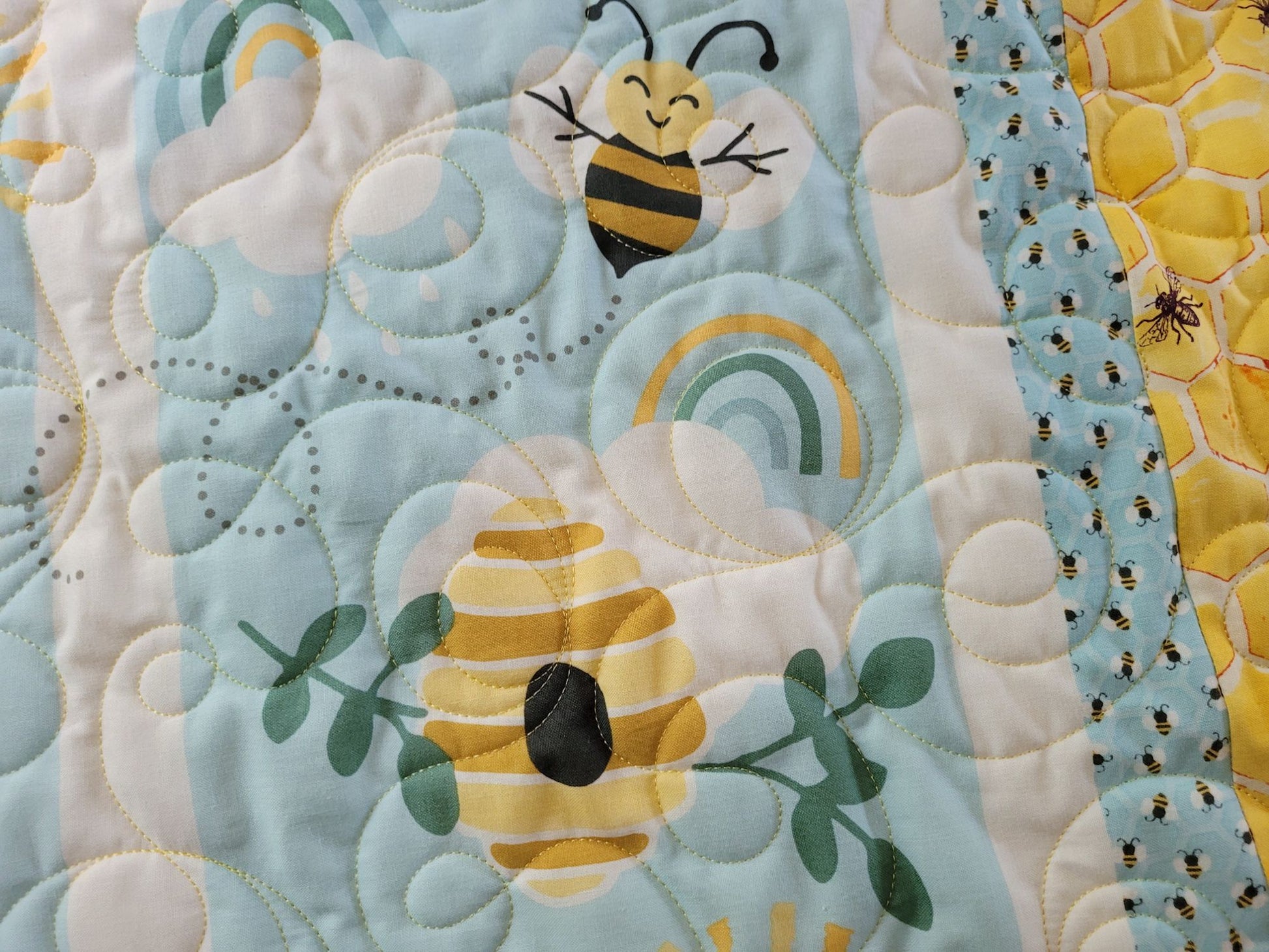 Close up detail of bees on the baby quilt
