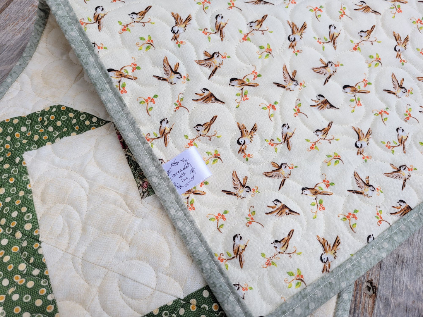 Back of the quilted table runner has bird pattern fabric.