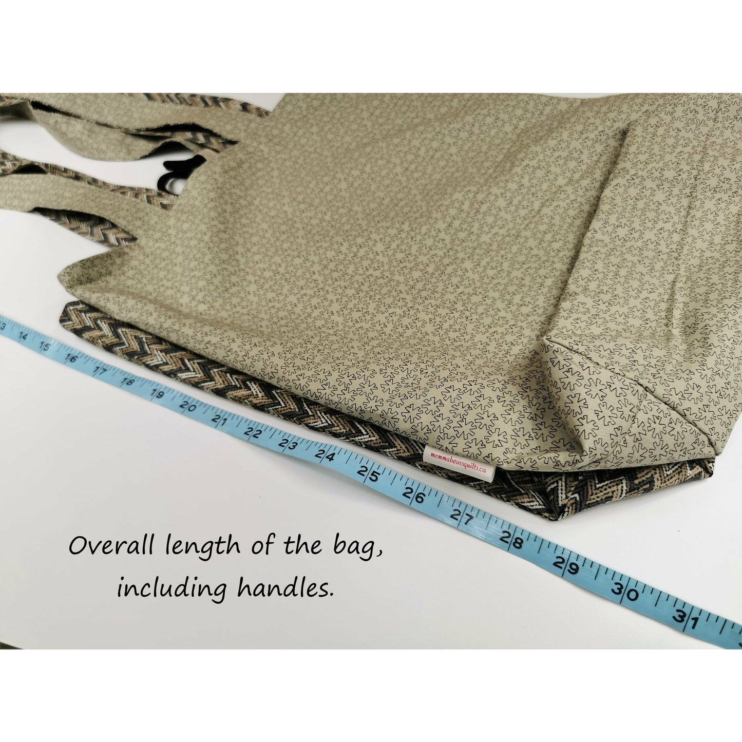 Image shows the overall tote bag length, including handles, is 31 inches.