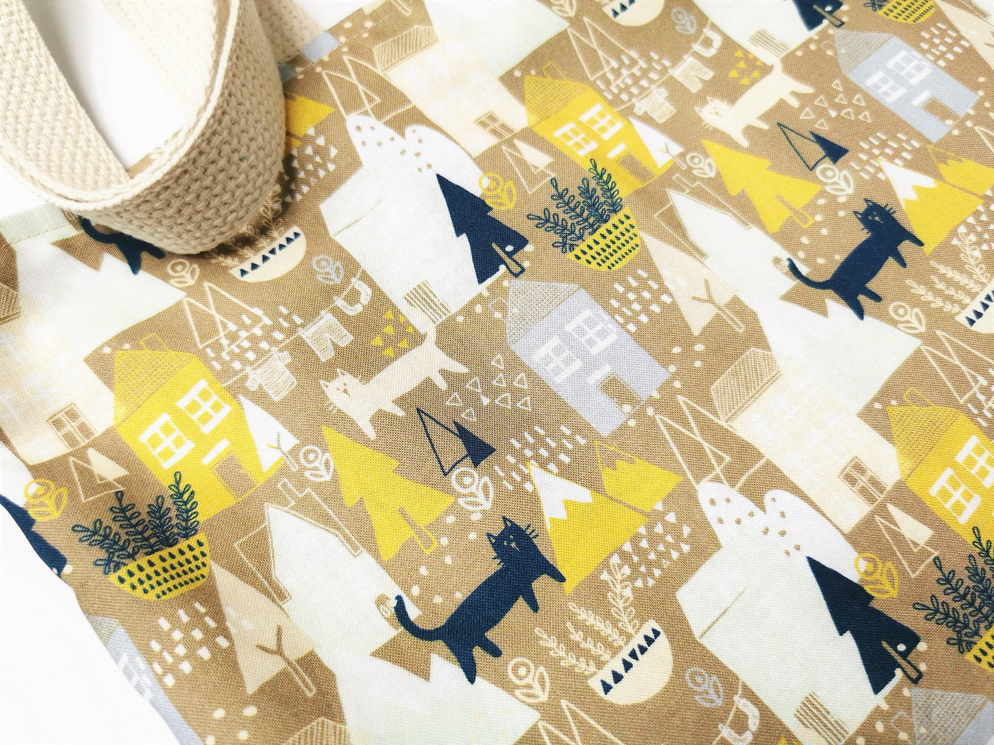 cotton fabric detail with village houses, trees and cats