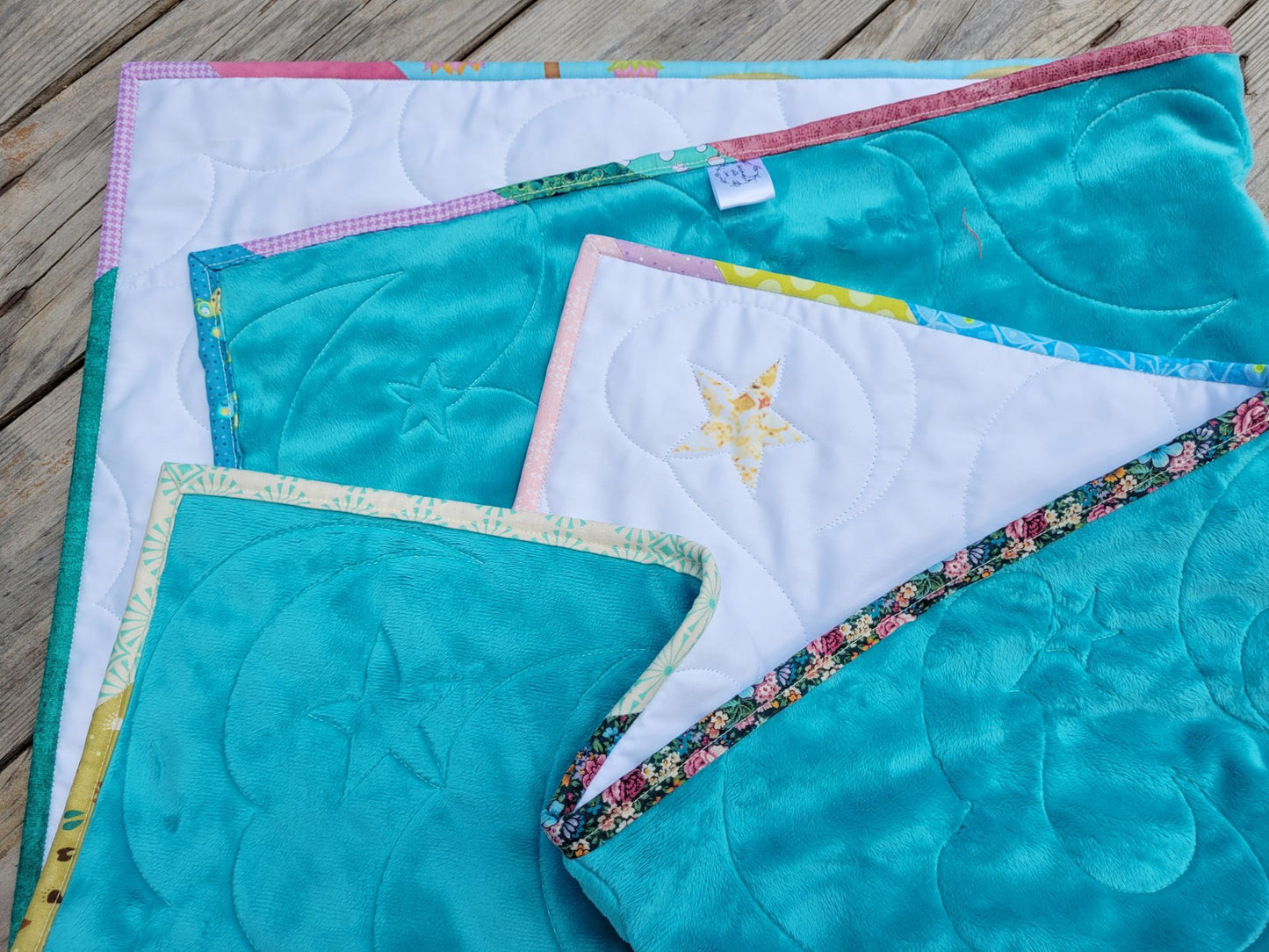 Soft teal backing and scrappy binding on bunny baby quilt.