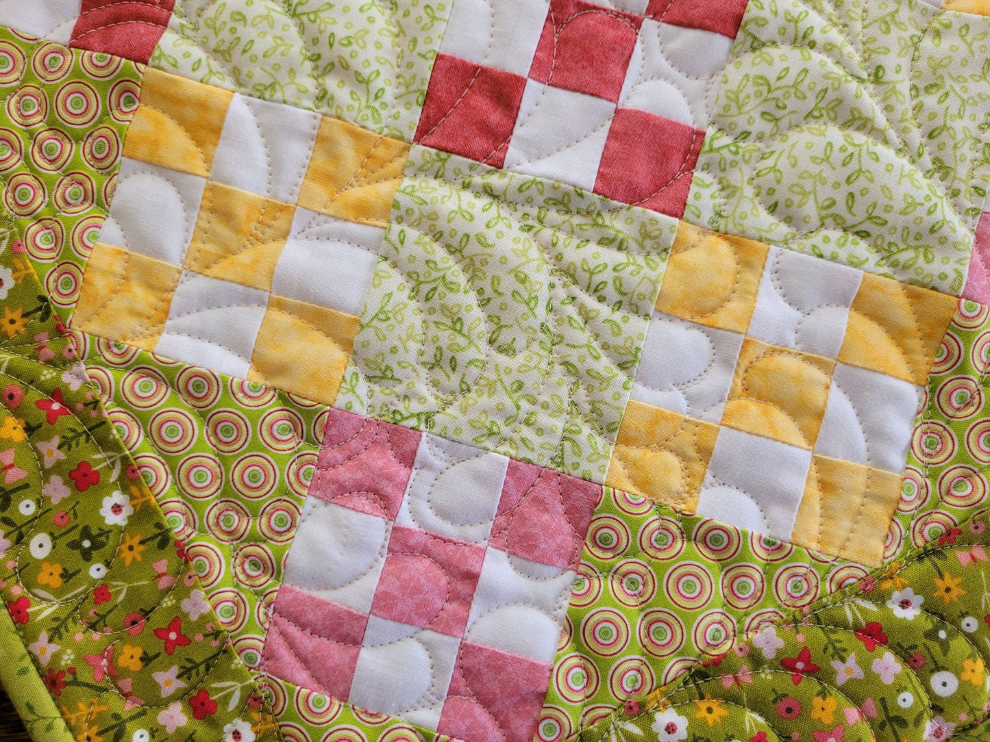 pink and yellow nine patch table quilt