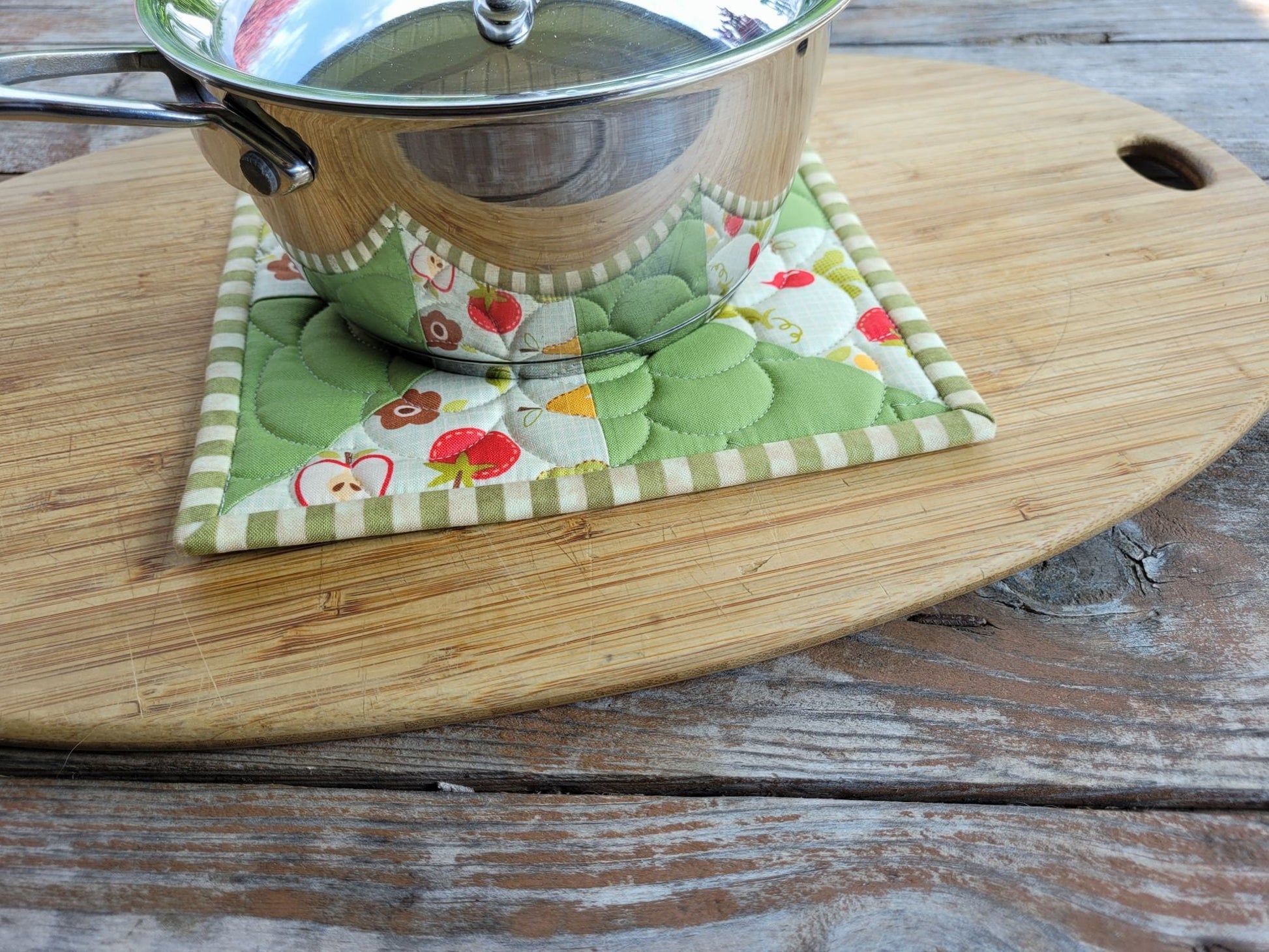 quilted potholder under a small size saucepan