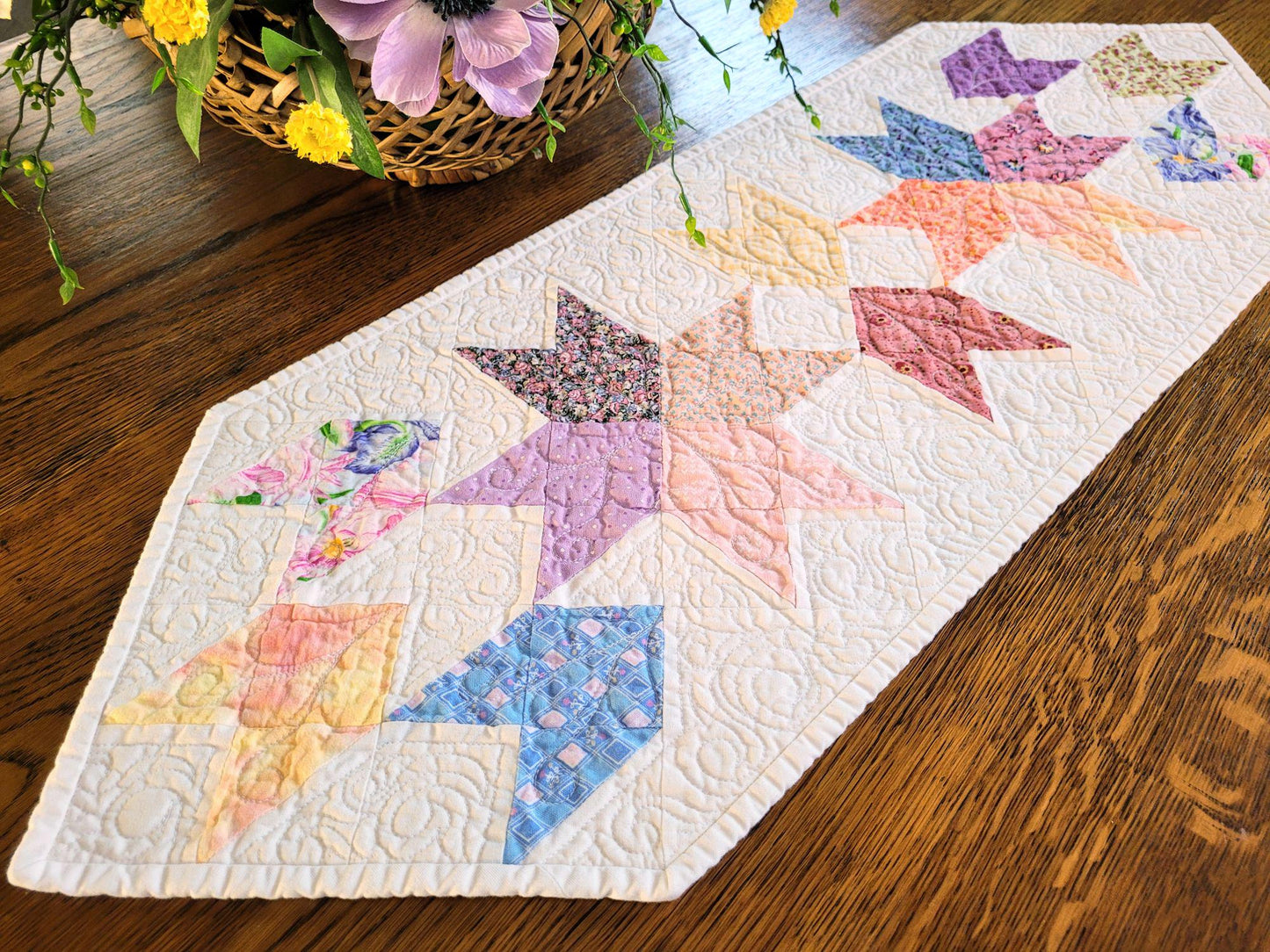 Close up of spring table runner on a wood surface with flower basket.