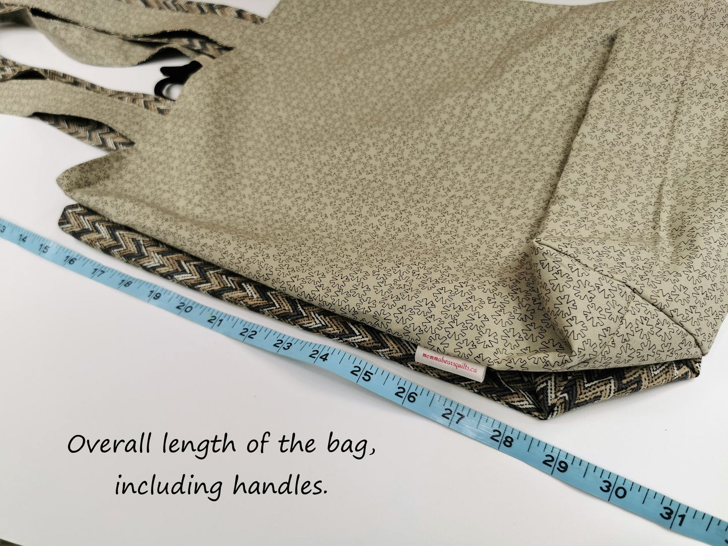 Image shows the overall tote bag length, including handles, is 31 inches.