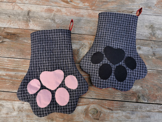 Overhead view of pet paw stocking for christmas, black and gray check with fur like quilting, choose pink or black toes