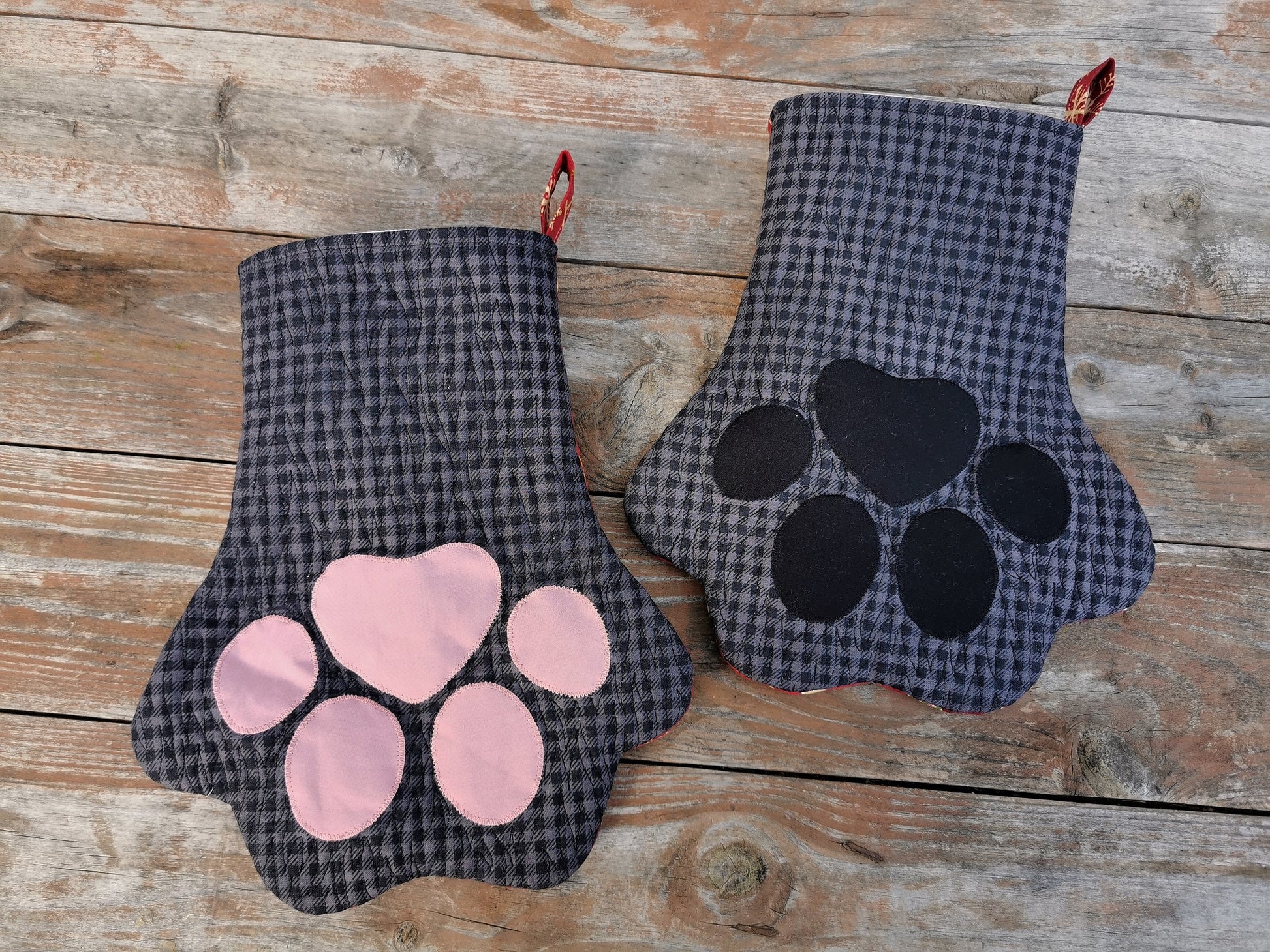Overhead view of pet paw stocking for christmas, black and gray check with fur like quilting, choose pink or black toes