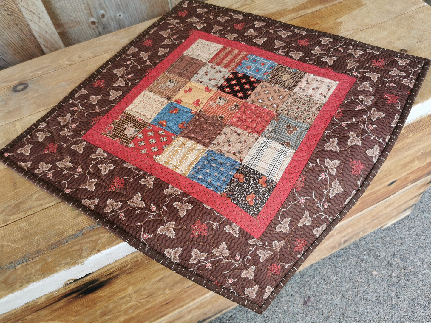 quilted table topper on wooden chest