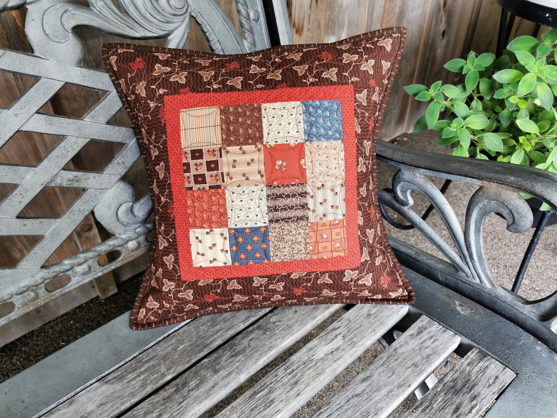 This rustic patchwork pillow is made with simple patchwork squares in coordinating, civil war fabrics. Lovely rich browns, red, blue and beige colors are both practical and pretty. 