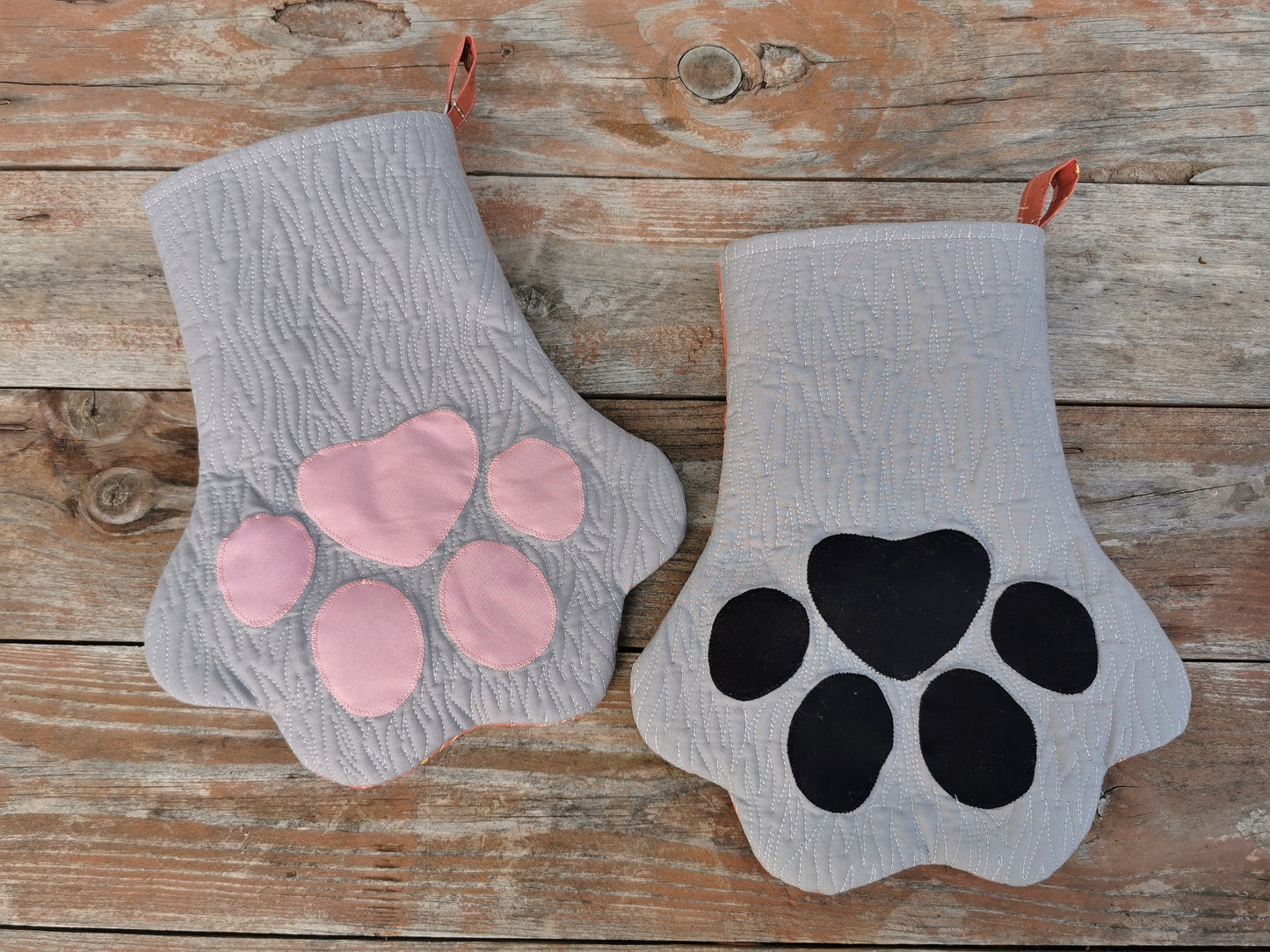 two gray paw stockings, showing both the pink and black toe options. Notice the fur like quilting that gives interesting detail.