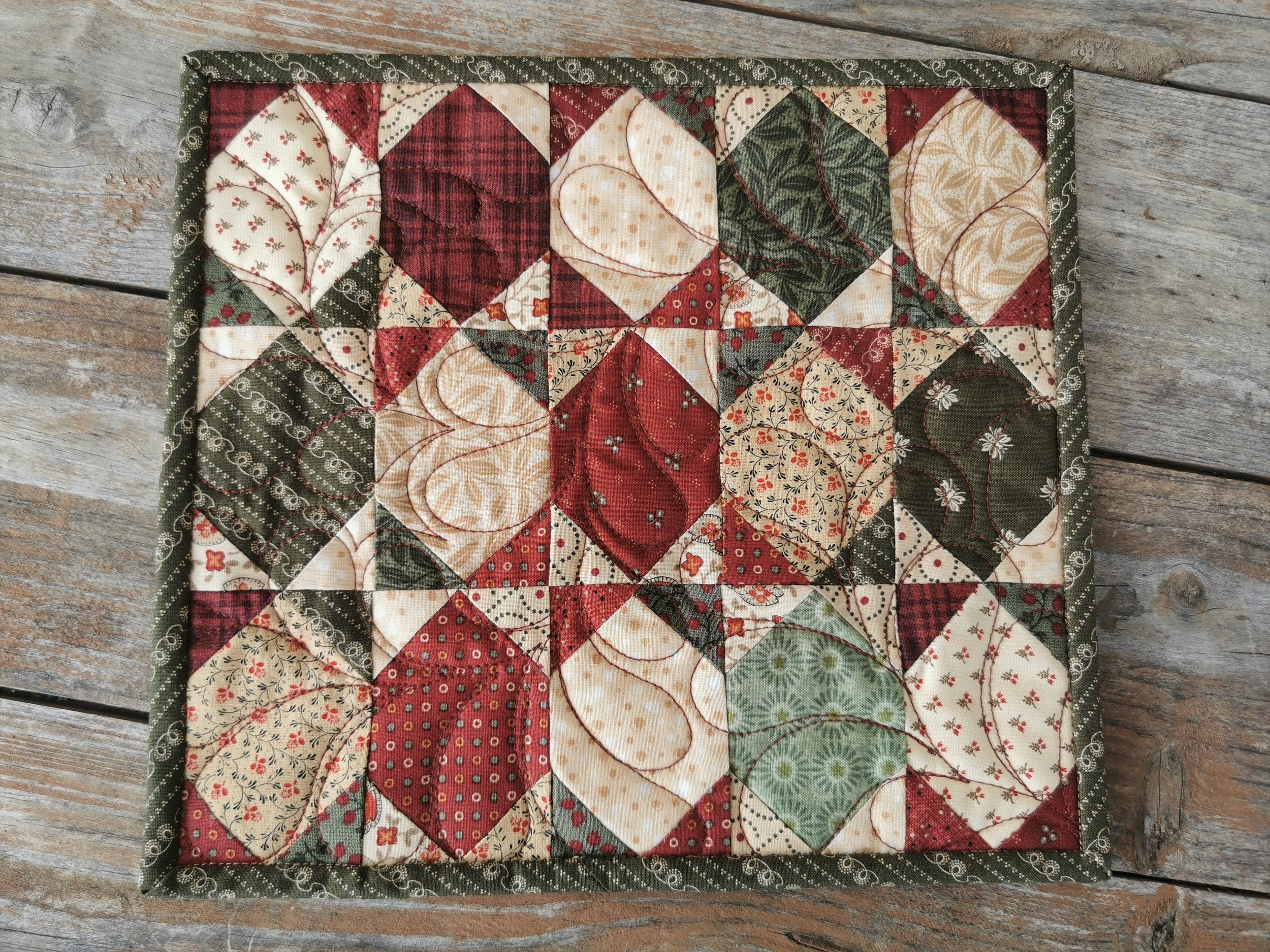 view of patchwork mini quilt on wooden table
