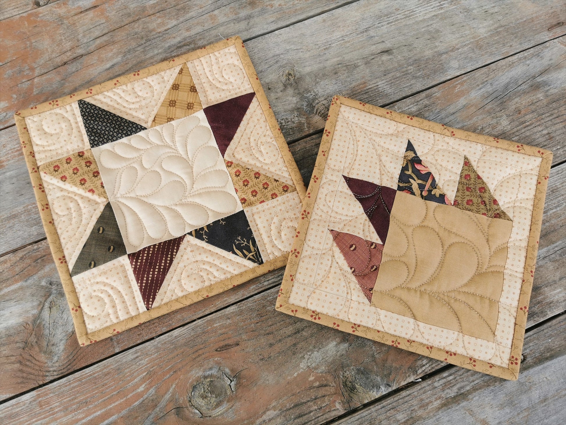 patchwork potholders shown side by side on wooden table