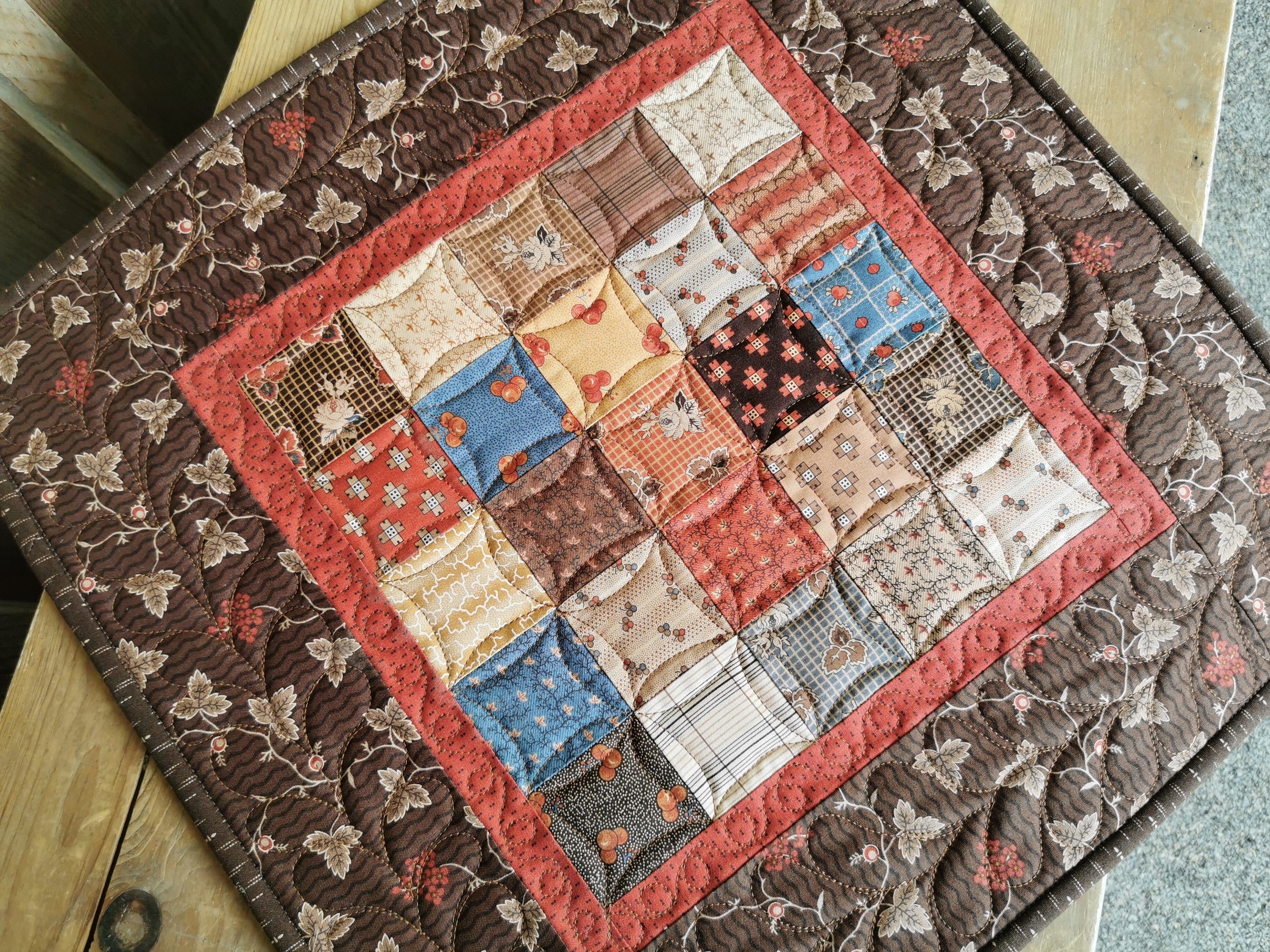 overhead view of the quilted table topper. Lighting enhances the quilting to show the texture