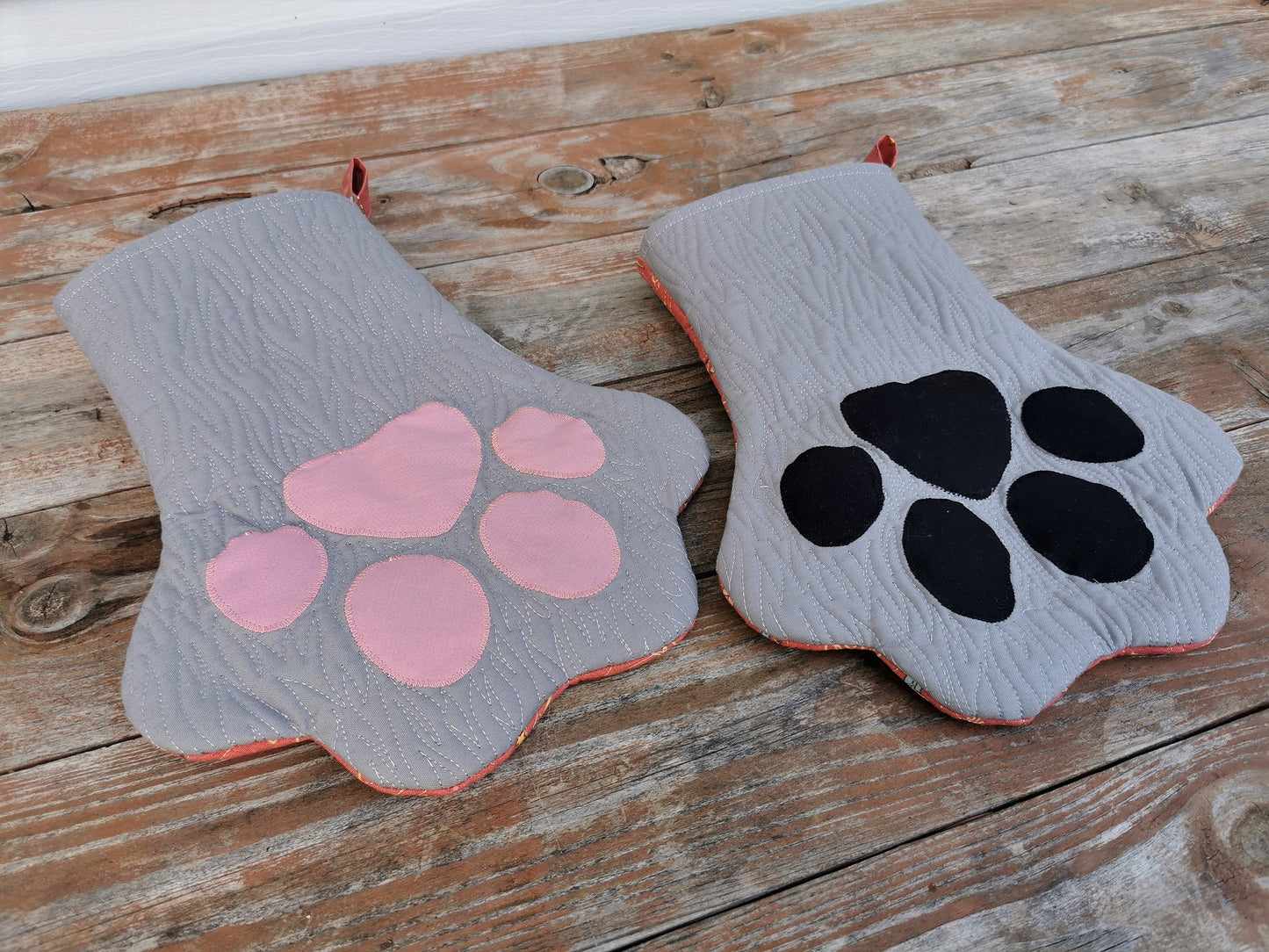 angle view of pet paw stocking for christmas, gray with furlike quilting, choose either pink toes or black toes