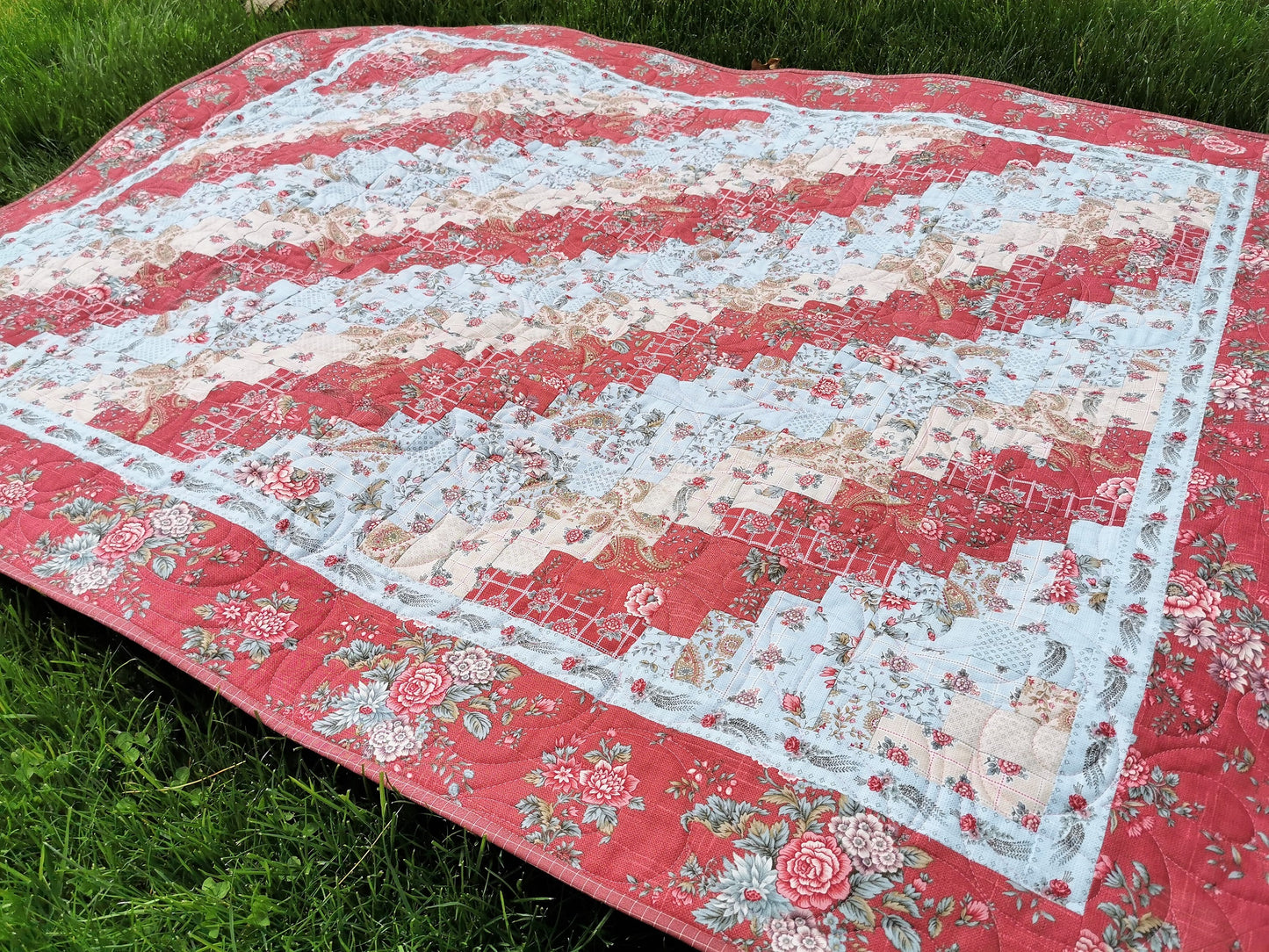 this lovely log cabin throw quilt features french floral fabrics in a coral rose, powder blue and cream color scheme. Quality cotton fabrics. 