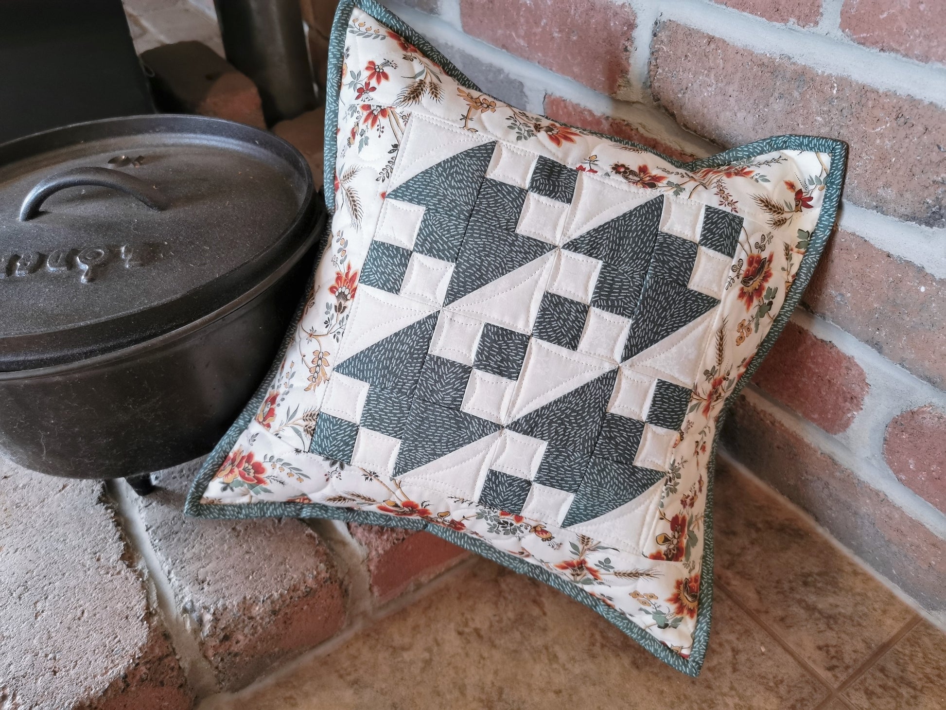 This 12 inch square throw pillow is the perfect accent. Teal and white patchwork surrounded by a coordinating floral border is light and summery.