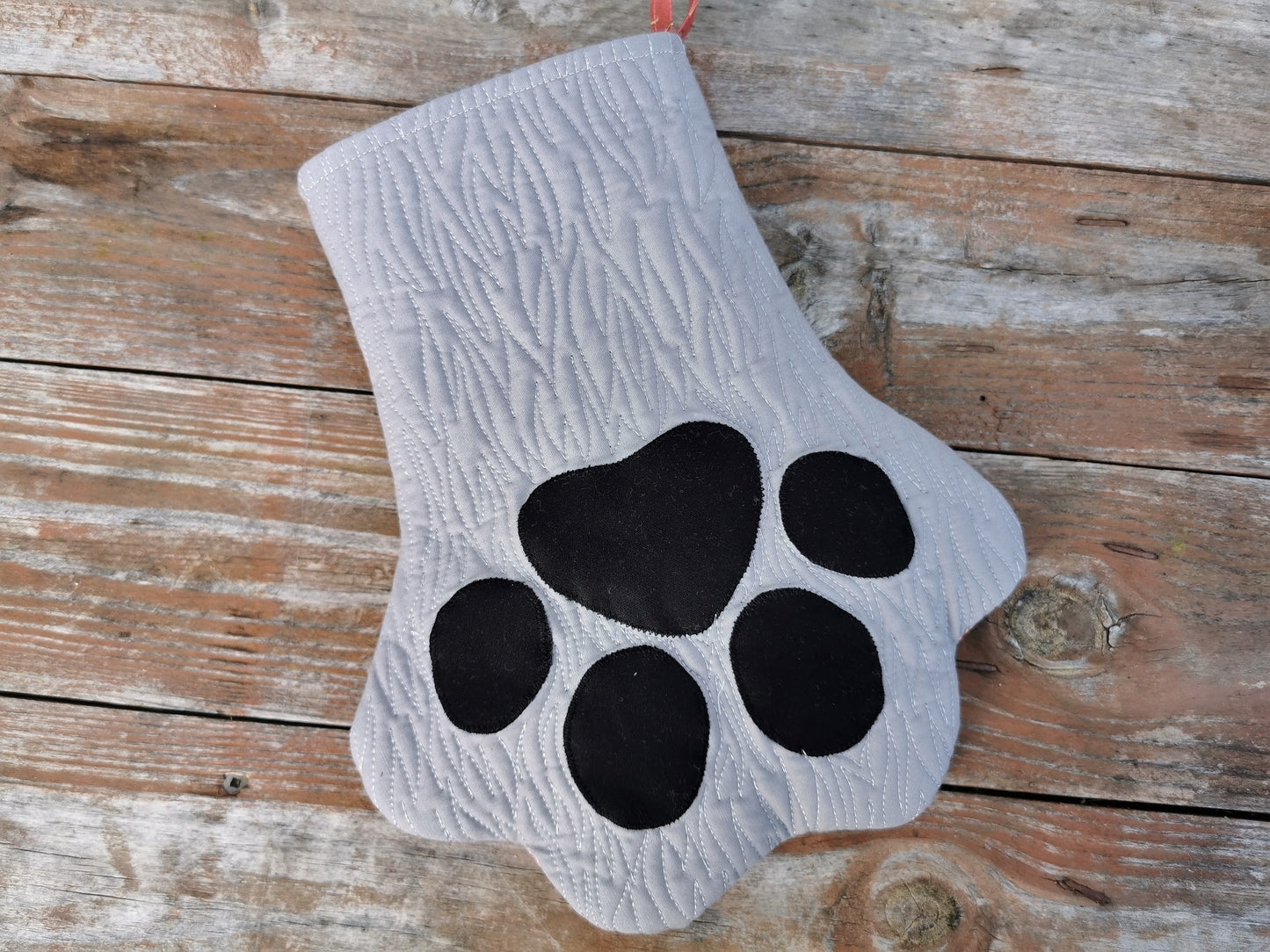 grey pet stocking with black toes and fur like quilting