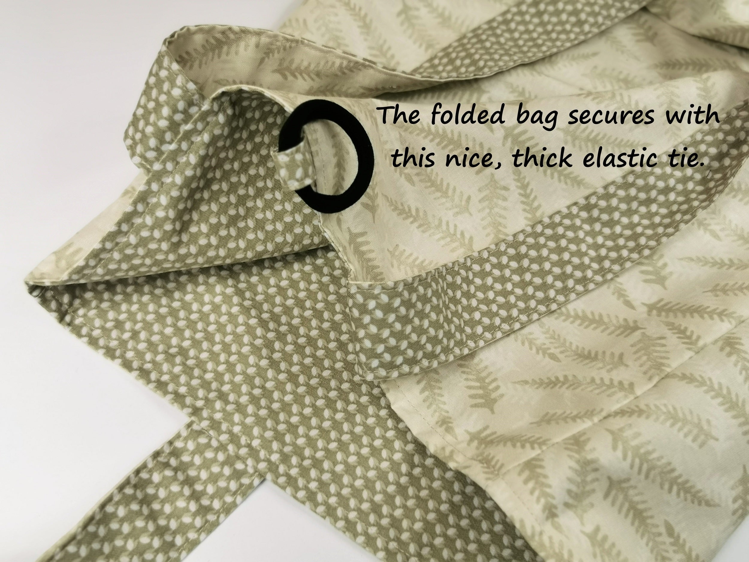 image shows the heavy duty elastic used for securing the bag once it is folded and rolled up.