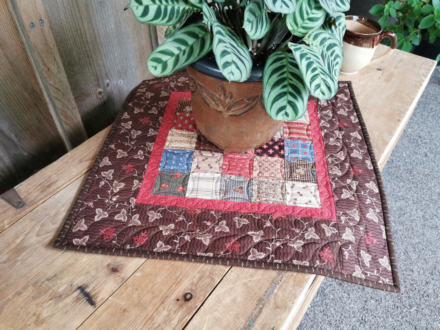 lifestyle shot of the table topper with plant sitting on it