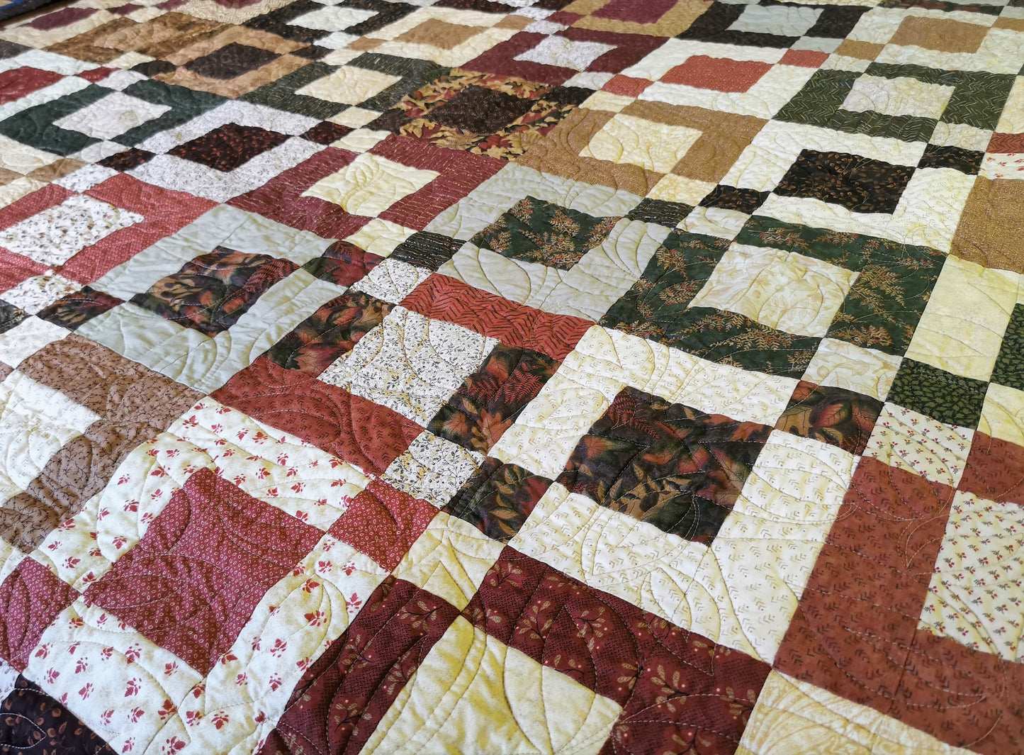 angle view of the quilt laid on a bed.