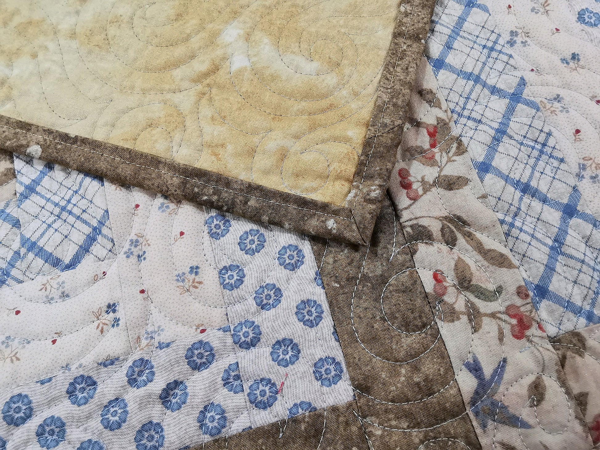 corner of the quilt is folded over to show backing