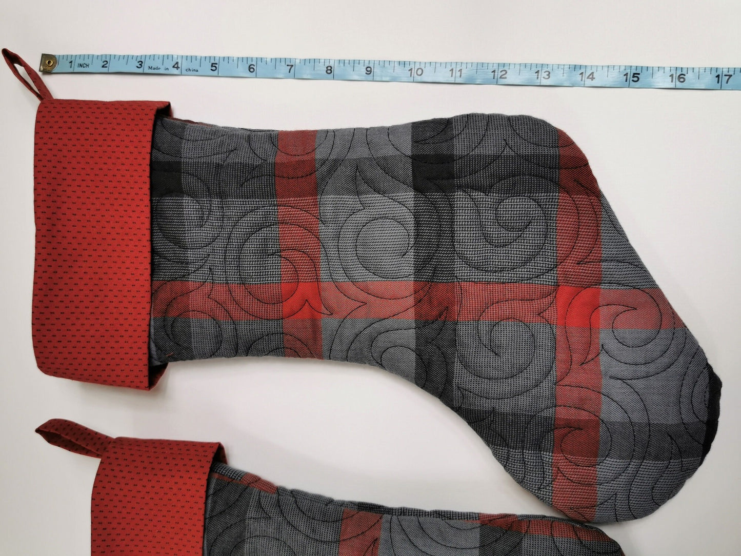 showing length of the quilted stocking with a tape measure
