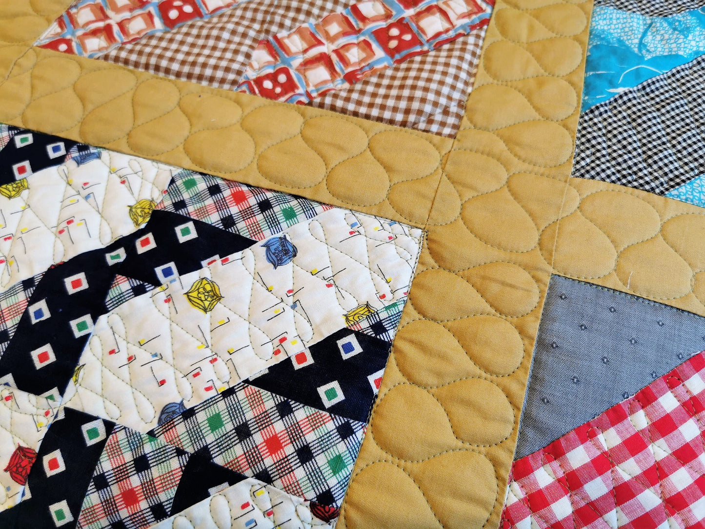 close up of vintage fabrics and custom border quilting