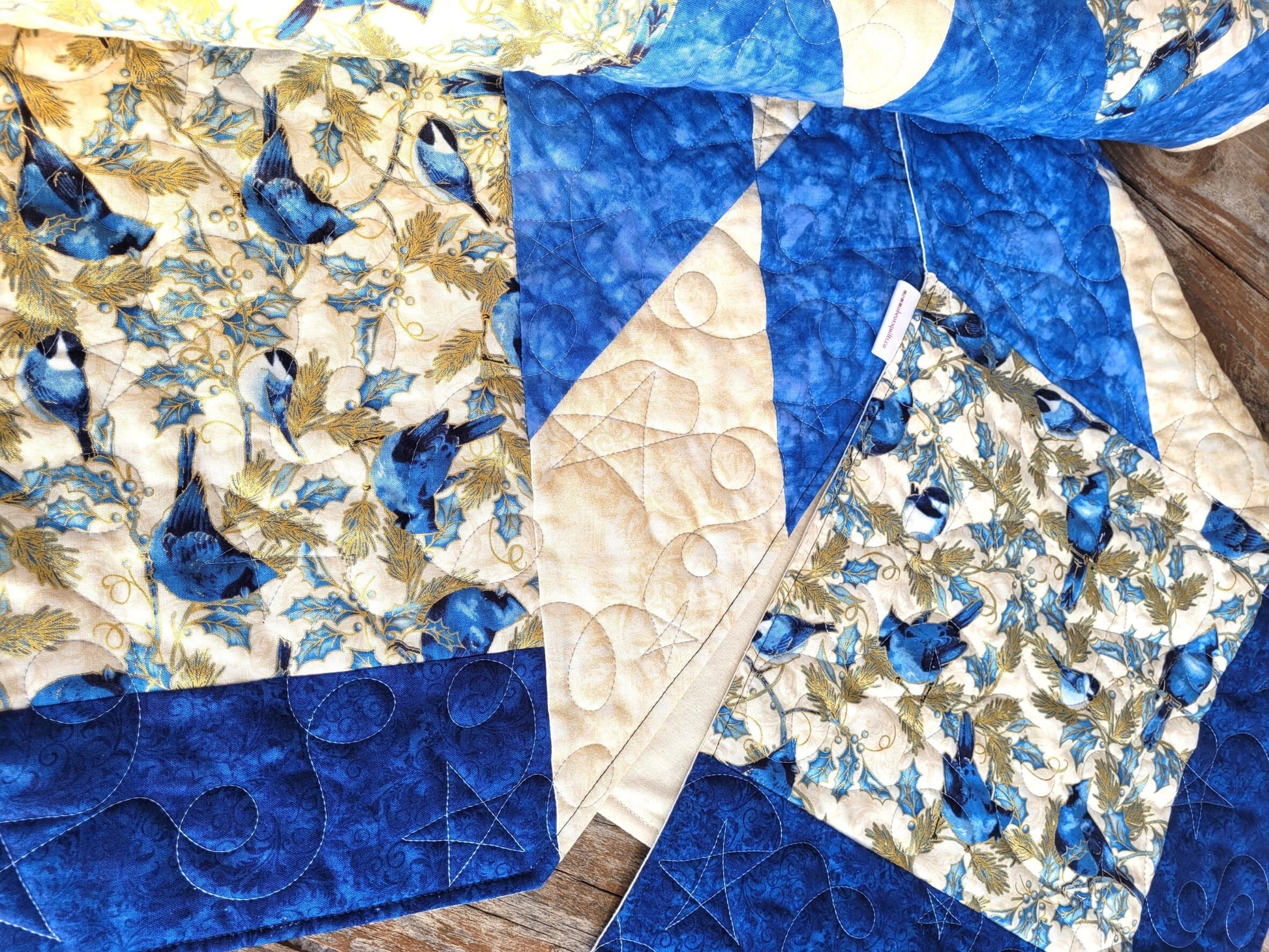 quilted tree skirt with birds in blue and white color scheme