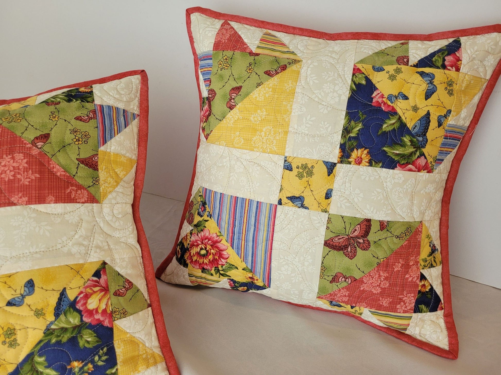 quilted pillow in scrappy bear paw pattern with summer floral prints