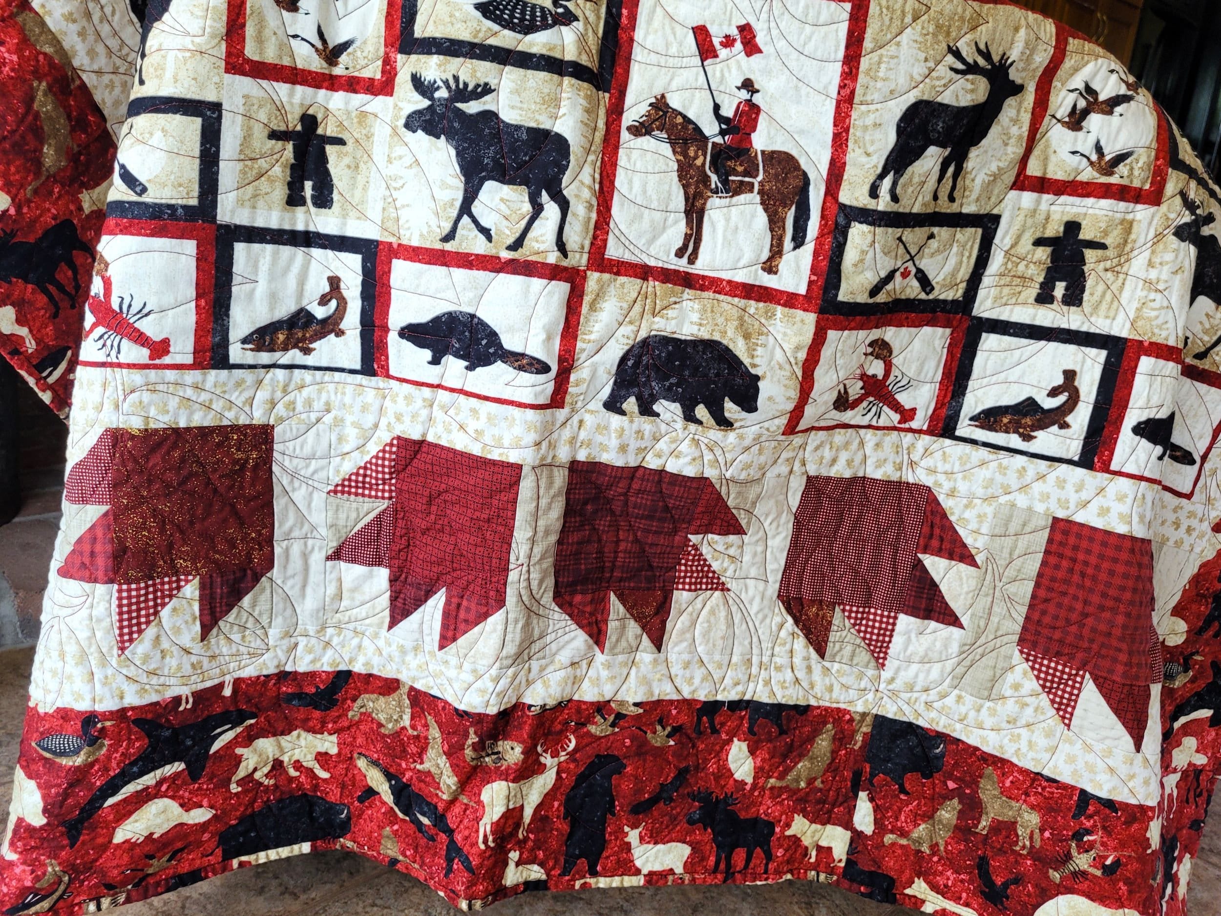 canada bear paw throw quilt with canadian wildlife symbols and themed fabrics