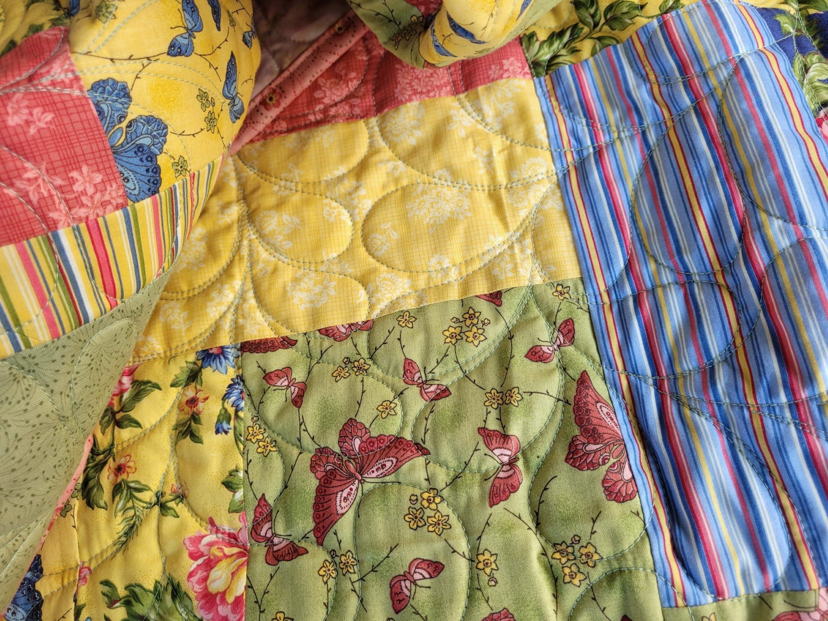 bright and colorful quilt with butterflies and flowers