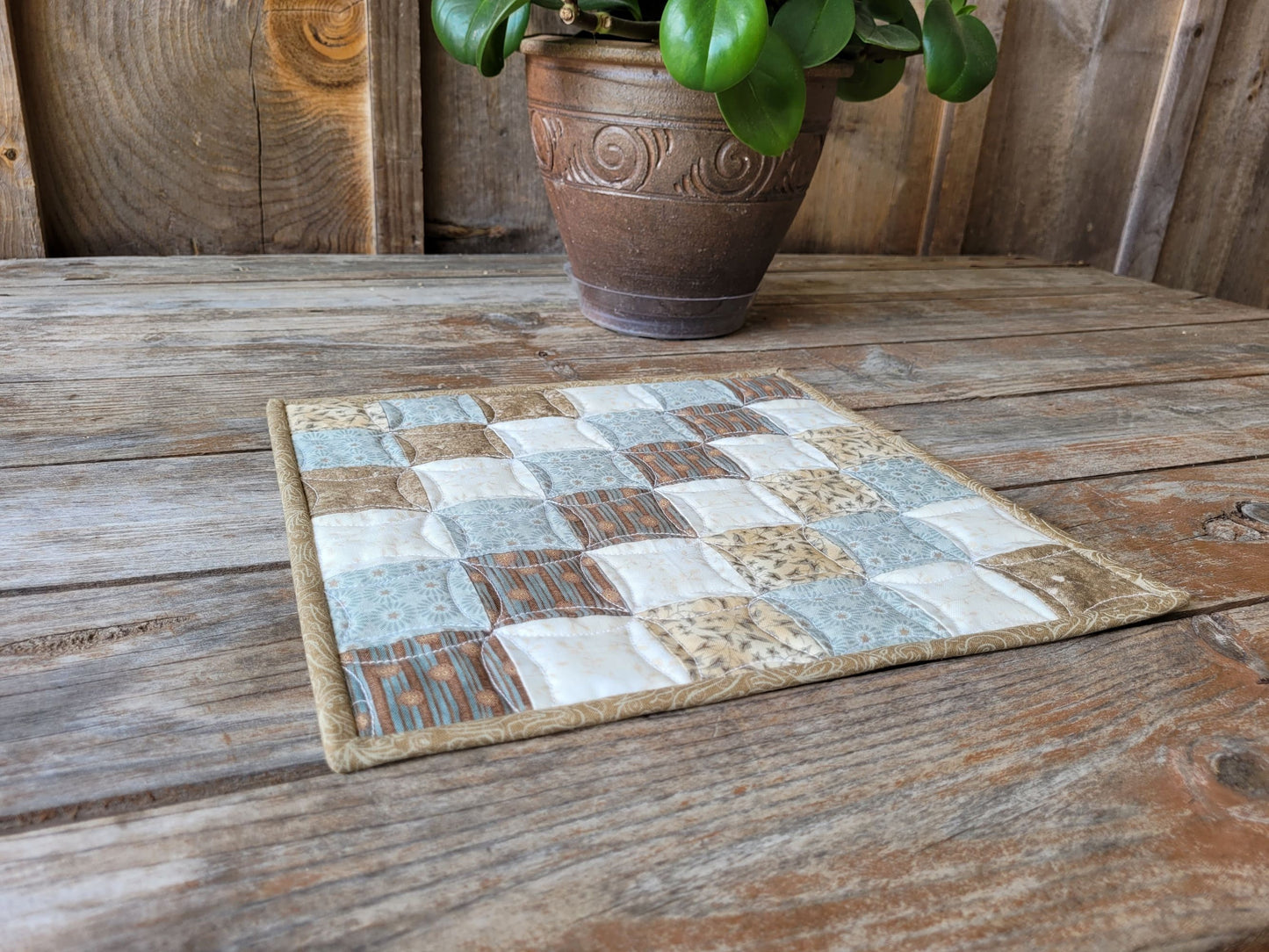 small square quilt in neutral patchwork