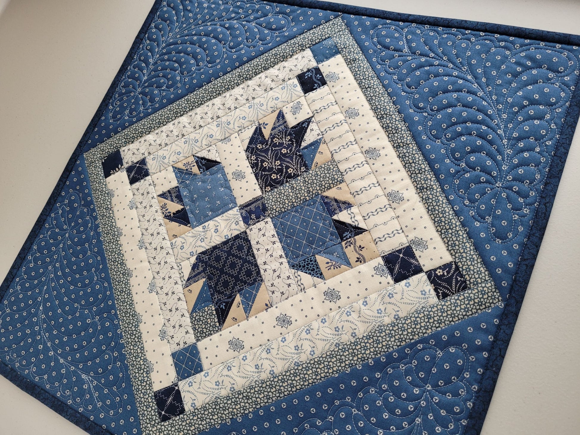 patchwork wall quilt in blue and cream