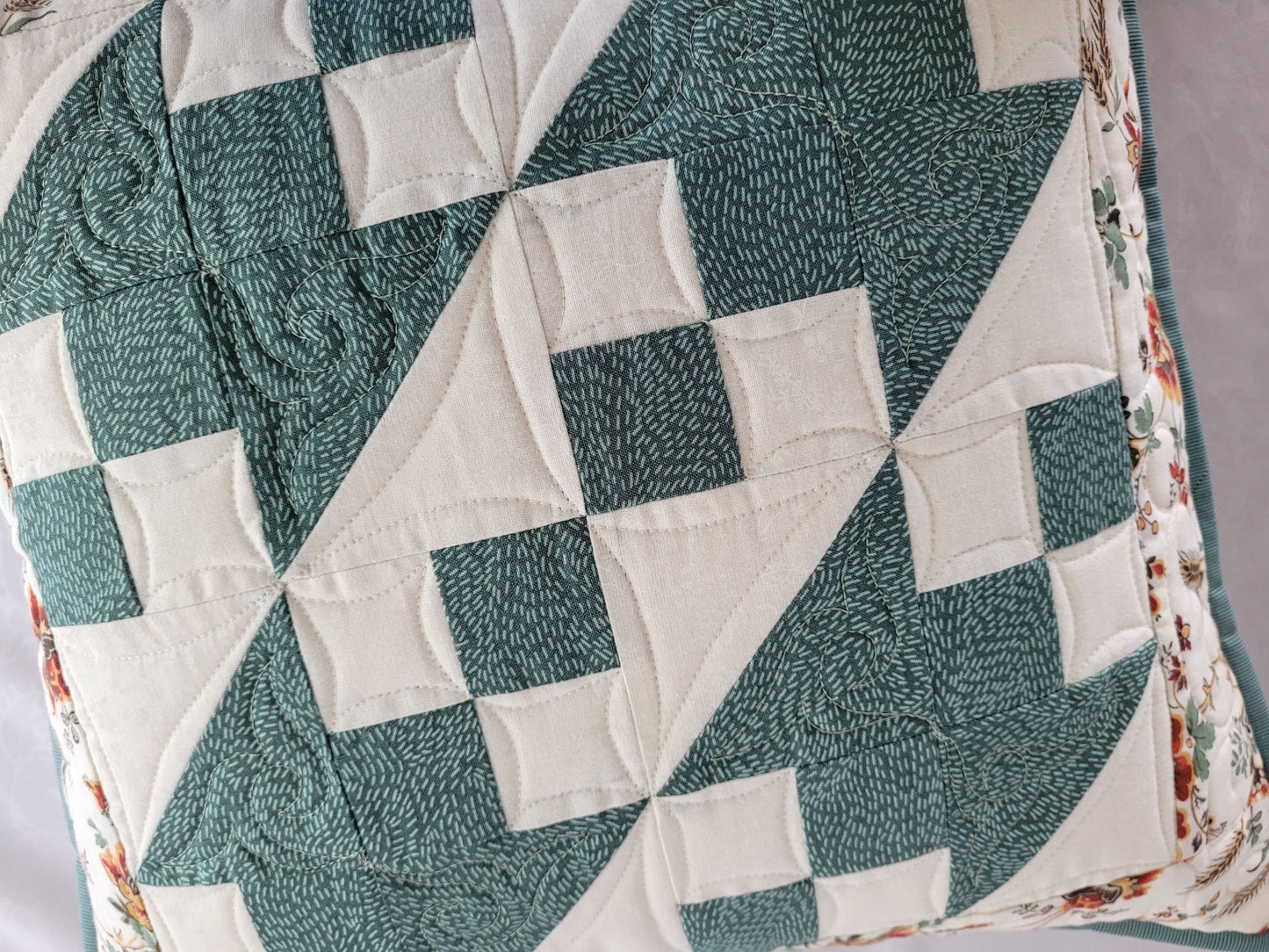 quilted pillow in teal and white