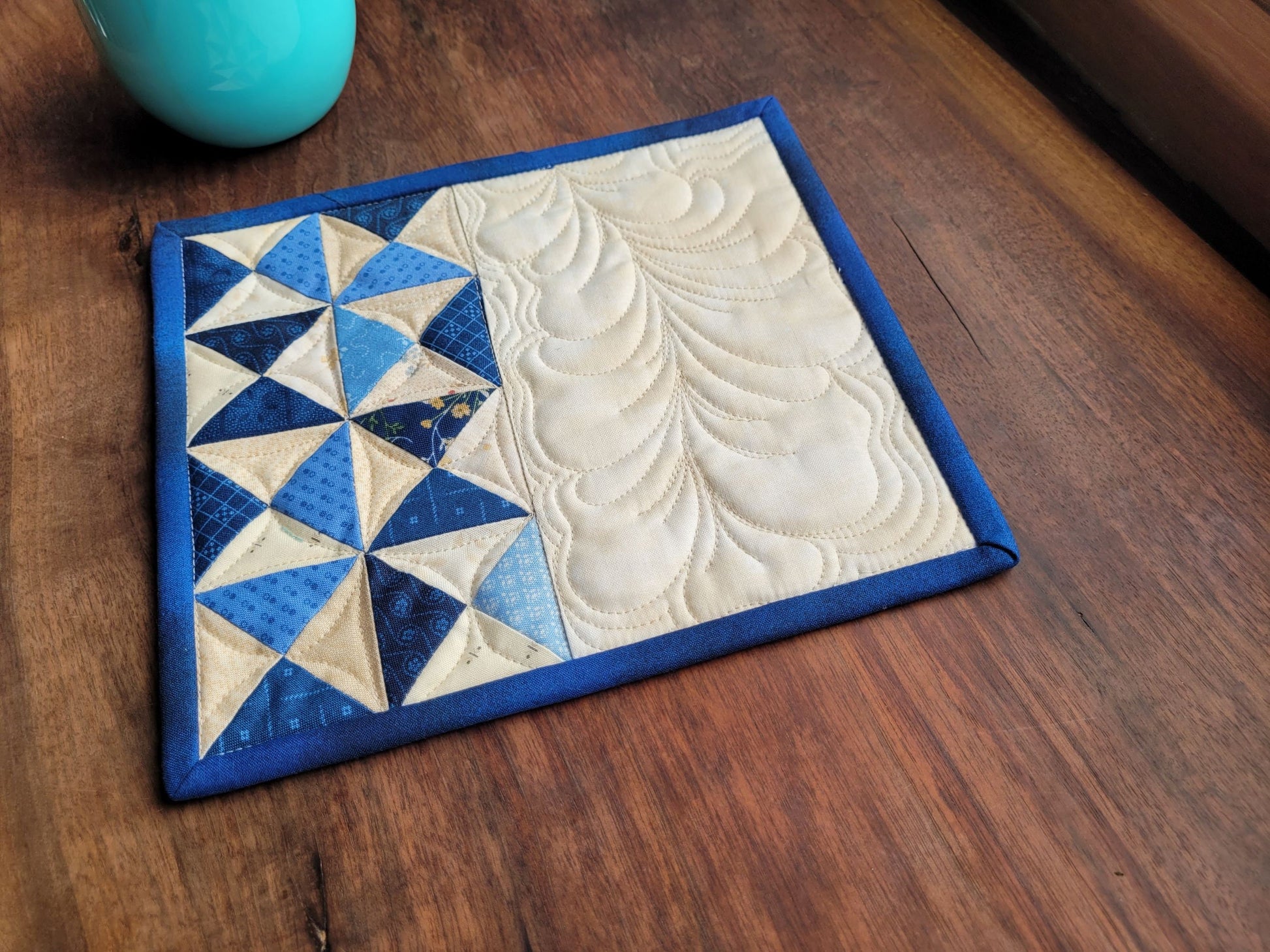 blue mug rug with dark binding