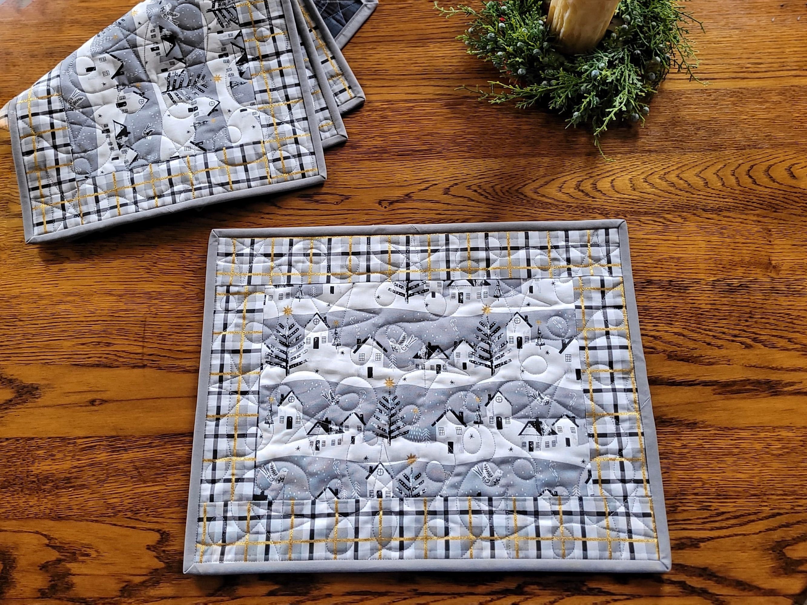 quilted winter placemats with snowy village and metallic accents