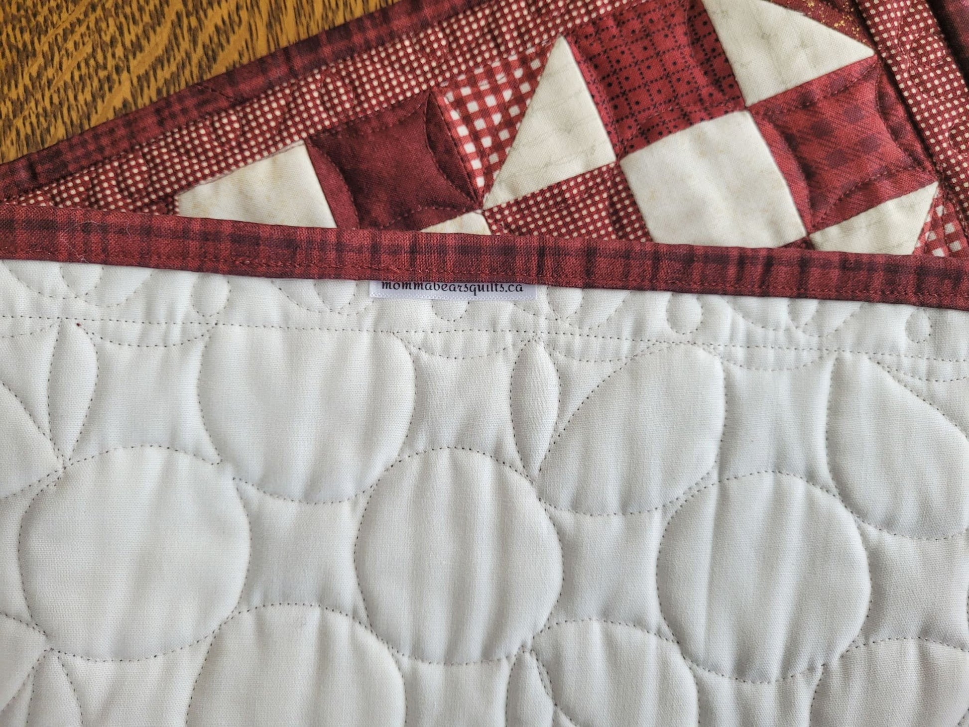 showing back of red scrap quilt