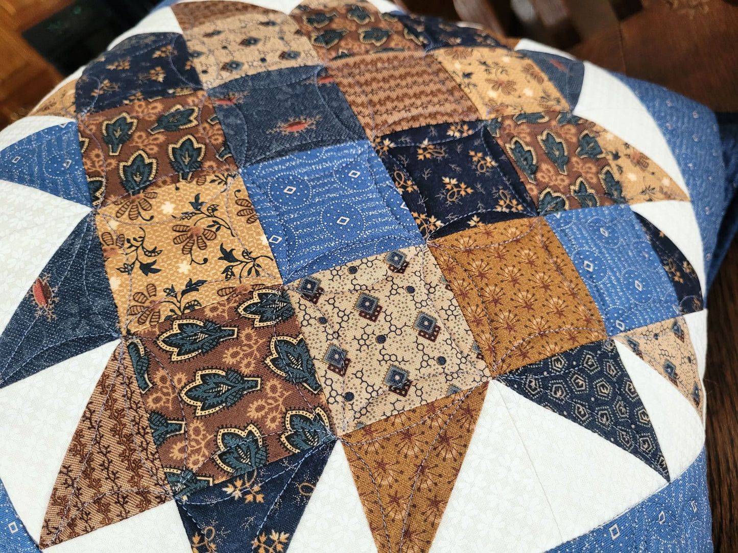 brown and blue patchwork pillow