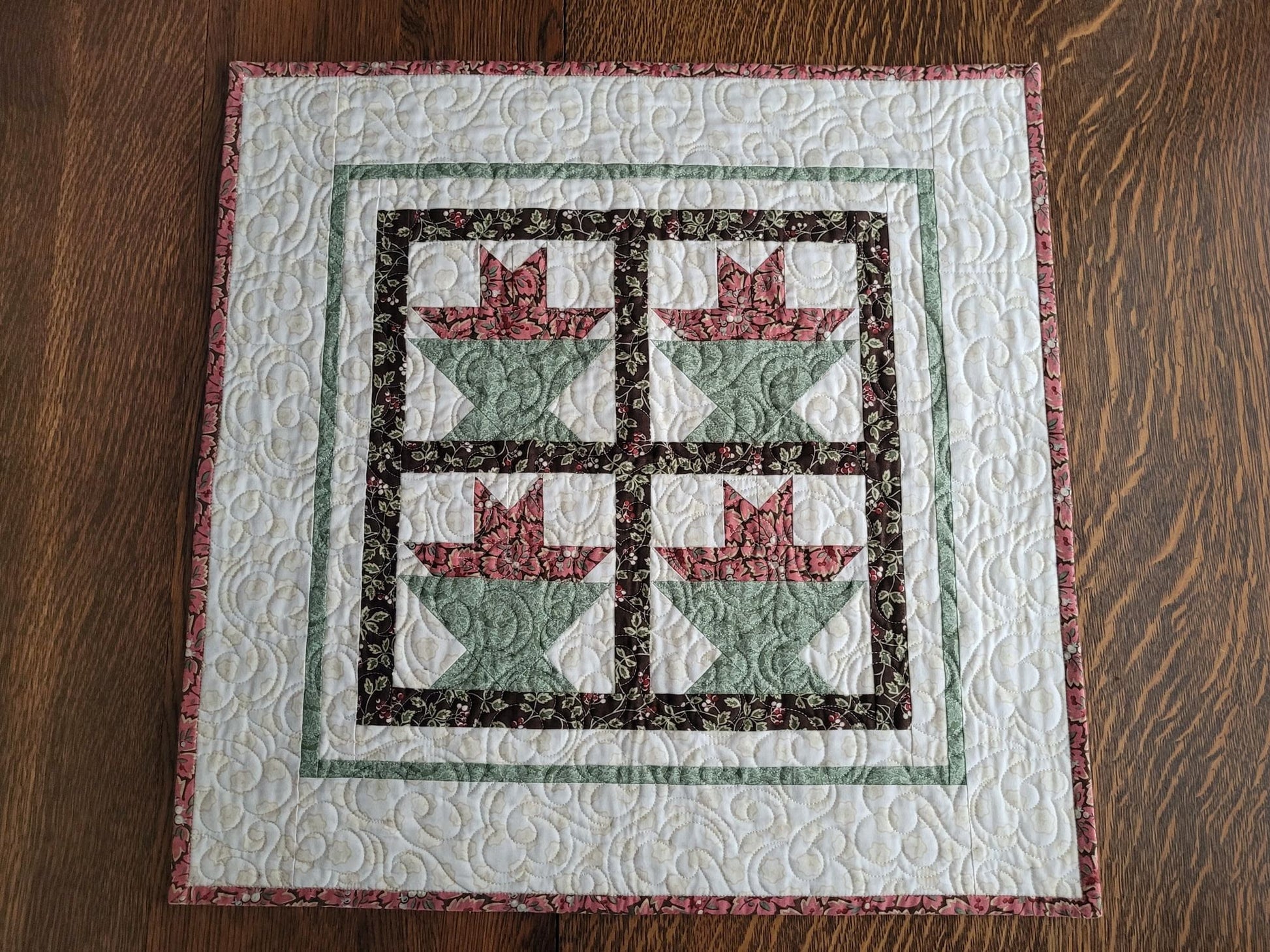 small square white quilt with four flower baskets