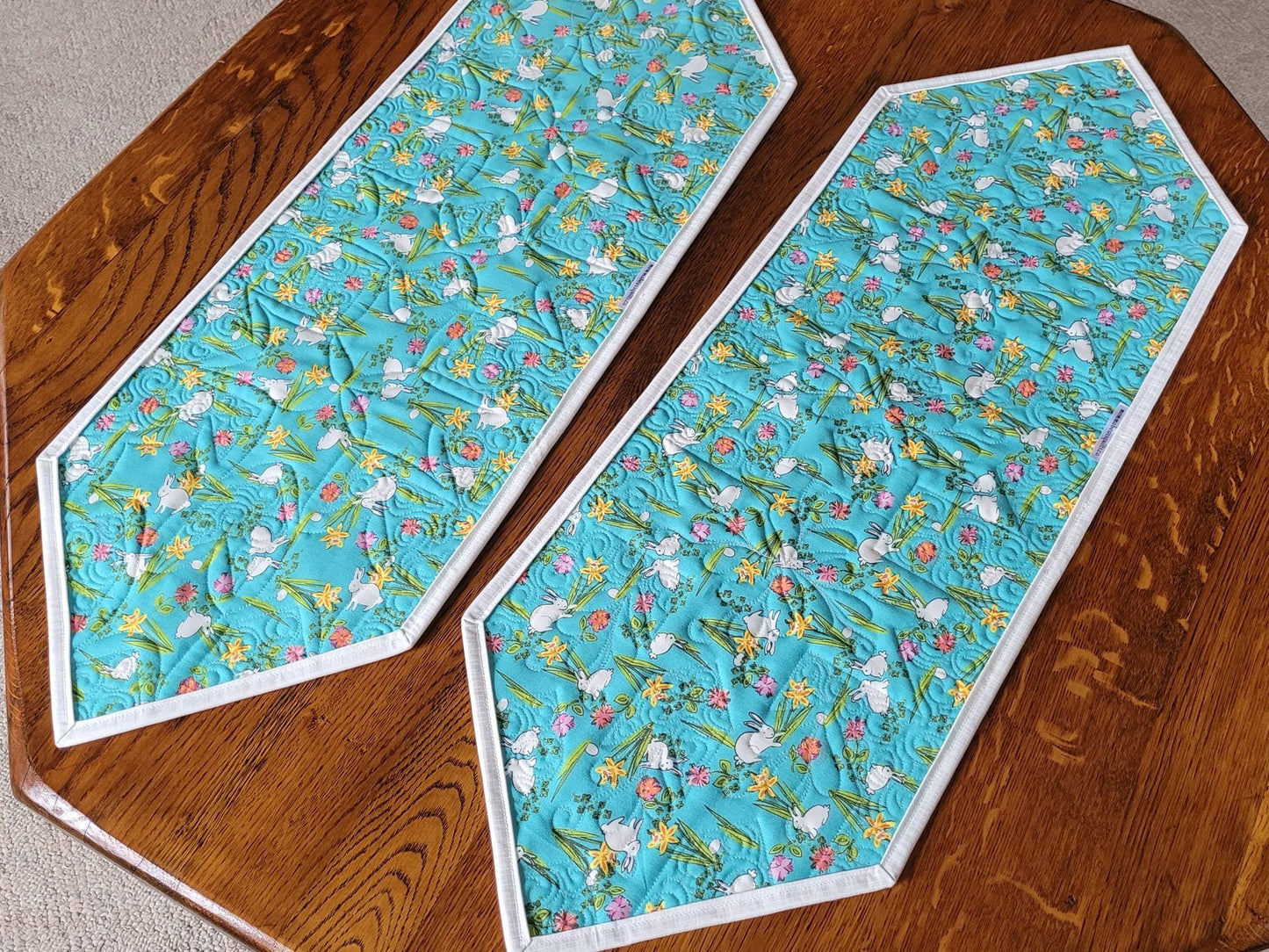 back of table runner has teal blue cotton print with white bunnies and daffodils