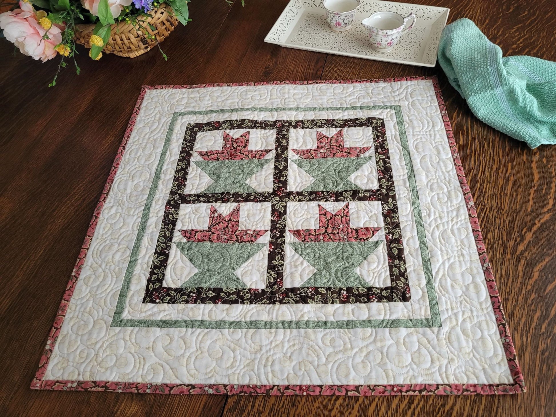 quilted table topper with four patchwork flower baskets